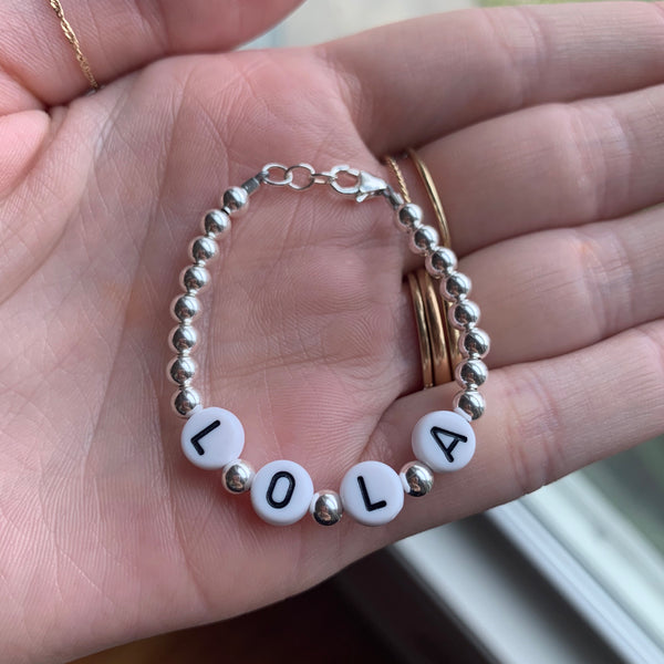 Black letters on white beads WITH metallics between