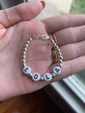 Black letters on white beads WITH metallics between