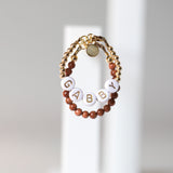 Gold letters on white beads WITHOUT metallics between