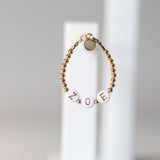 Gold letters on white beads WITH metallics between