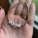 Gold letters on white beads WITHOUT metallics between