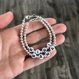 Black letters on white beads WITH metallics between