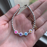 Pastel letters on white beads WITH metallics between